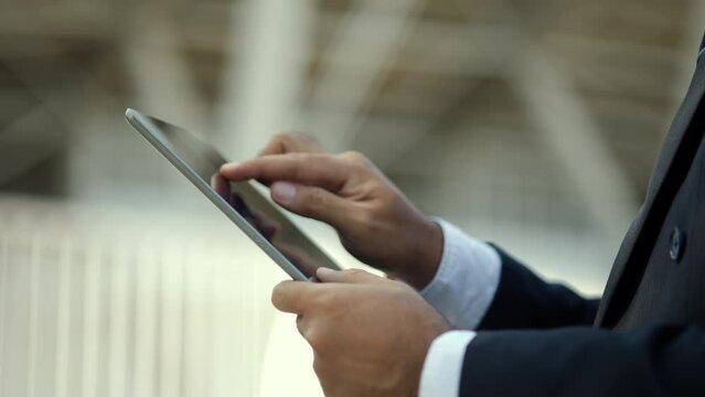 Close-up hand of Real estate project manager or architect looking using tablet for checking and consultant to inspection in construction site buildin. Real estate property concept.