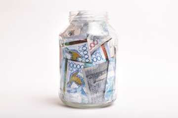Kazakhstan banknotes of a large denomination in a transparent bank on a white background.