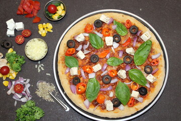 Pizza with vegetables like Paneer, Paprika and Olives