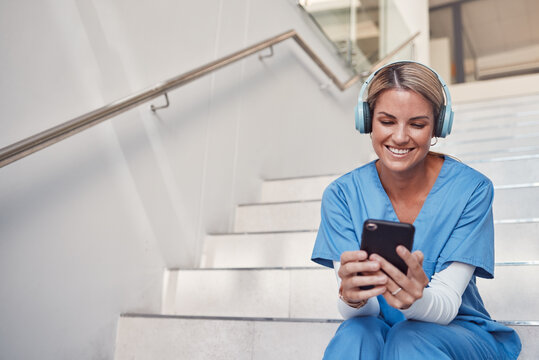 Doctor, phone and stairs for consultation, communication or video call outside hospital for health advice. Happy woman nurse smiling in healthcare with smartphone and headset for telemedicine