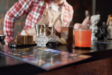 menu and cocktail glass on the bar counter .