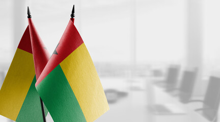 Small flags of the Guinea Bissau on an abstract blurry background