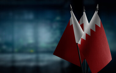 Small flags of the Bahrain on an abstract blurry background