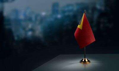 A small East Timor flag on an abstract blurry background