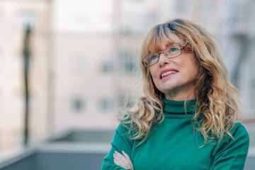 mid adult woman wearing glasses smiling outdoors