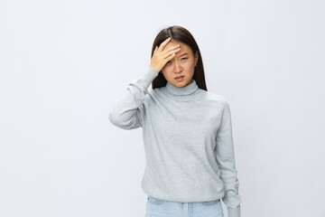 Asian woman holding her hand to her head for severe headache, migraine white background