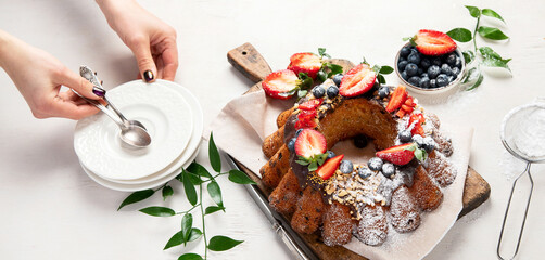 Pound Cake cake with strawberry, close-up on the table. Horizontal view from above..Pound Cake cake with mint and strawberry close-up on the table. Horizontal view from above.