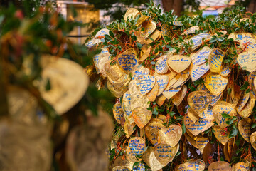 Thai buddhist golden leaves with wishes tied to Bodhi tree. 
