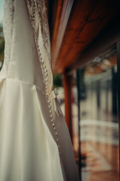 Brides wedding dress front of the window