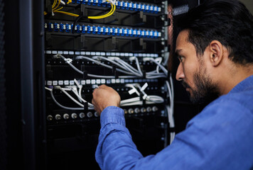 Engineer, server room and man with cable connection for software update or maintenance at night....