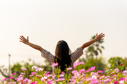 Happy woman raiseก open arms arms in flower garden, lifestyle and healthy confidence relax woman concept.