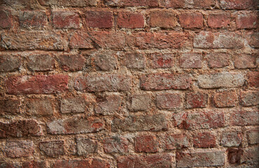 Old brick wall, old texture of red stone blocks closeup