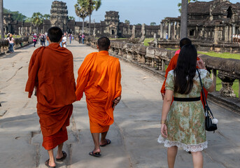 Undefined monks and tourists walk at Angkor Wat complex. Siem Reap. Cambodia