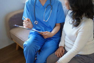 Portrait of a female doctor holding a patient clipboard to discuss and analyze the patient's...