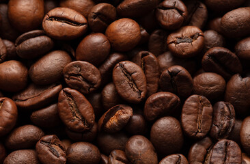 Grains of black coffee as a background.