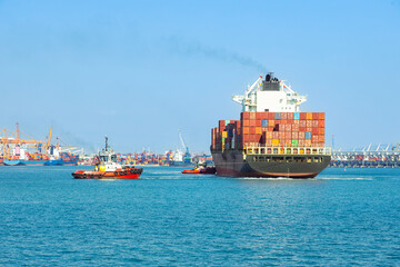 Fototapeta premium Large cargo container ship sails in the seaport