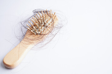 Hair loss fall with comb brush isolated on white background.