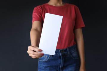 Woman showing blank white flyer brochure booklet. Leaflet pamphlet paper sheet display for...