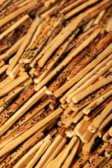 Pretzel bread sticks with sesame seeds. Delicious pretzels in bulk. close up
