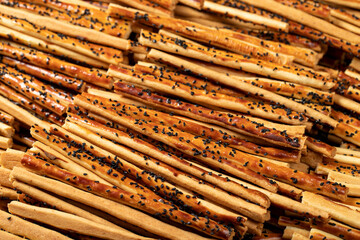 Pretzel bread sticks with sesame seeds. Delicious pretzels in bulk. close up