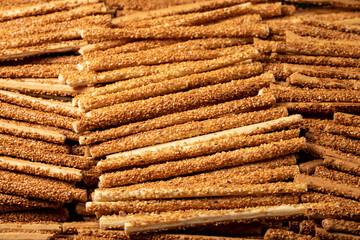 Pretzel bread sticks with sesame seeds. Delicious pretzels in bulk. close up