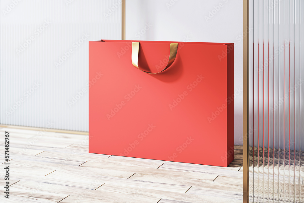 Poster perspective view on blank red paper shopping bag with place for your brand name or text on light woo