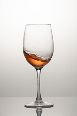 Splash of rose wine in glass, frozen motion