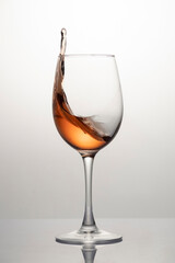 Splash of rose wine in glass, frozen motion