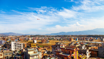 The airplane takes off from Kathmandu city, Nepal. Landscape of Kathmandu in winter blue sky....