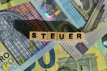 Das Wort Steuer und mehrere Euroscheine - obrazy, fototapety, plakaty