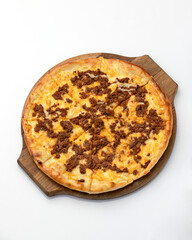 Pizza with minced meat. Pizza with cheese and meat is cut into pieces on wooden board. Italian cuisine. Fast food. Isolate on white background. Top view. Copy space. 