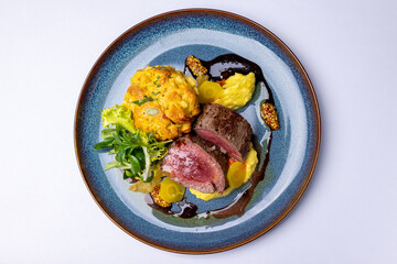 Veal tenderloin, yellow carrot puree, potato muffin, red wine sauce