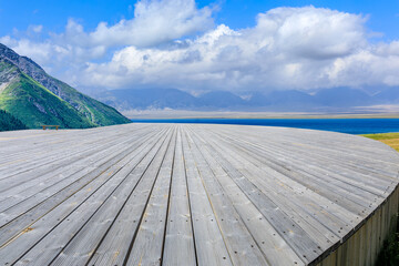 Empty wooden square and mountain with lake natural background in Xinjiang, China.