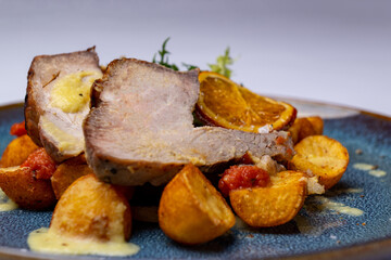 Roast pork on citrus with roast potatoes 