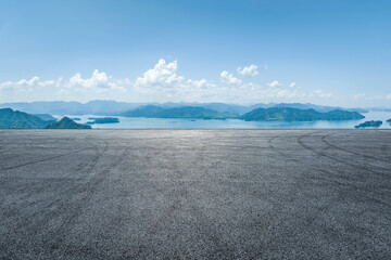 Asphalt road and lake with mountain natural background