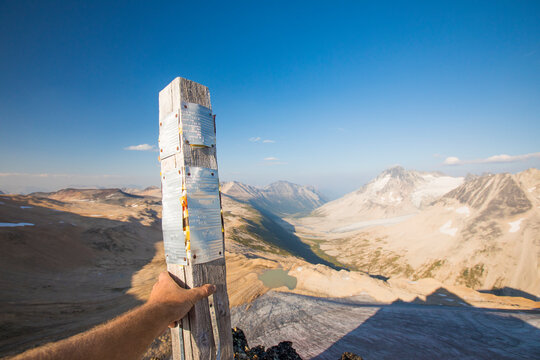 Man holds mining claim post above Athelney Pass, British Columbia