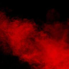 Red color powder explosion on black background.Freeze motion of red dust particles splashing.