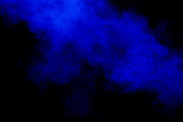 Blue dust explosion on black background. Freeze motion of color powder splash.
