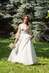 Fototapeta na wymiar Girl in a wedding dress in nature.