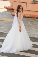 Fototapeta na wymiar Bride in a wedding dress on a pedestrian crossing.