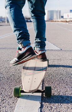 Close-up of anonymous man on longboard