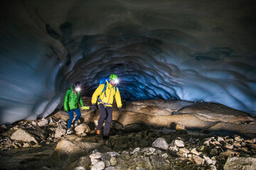 Couple exploring ice cave near Vancouver, Canada.