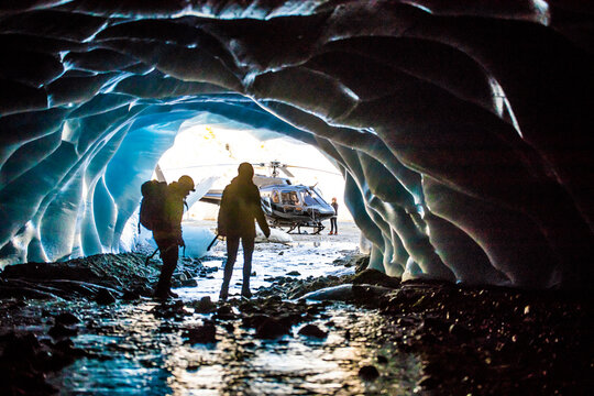 Helicopter tour brings couple to explore glacial cave.