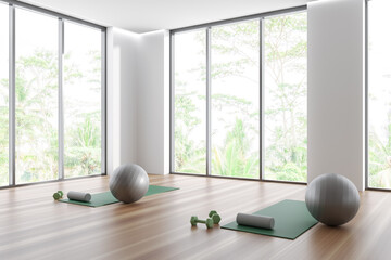 Bright fitness gym interior with exercise two mats, balls, dumbbells