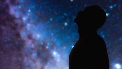 Fototapeta na wymiar Silhouette of a man with Milky Way starry skies.