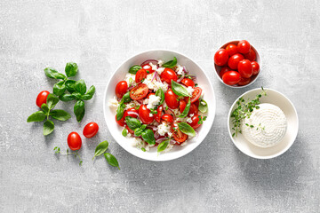 Salad with tomato, italian ricotta cheese and basil, top view