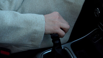 female hand on a car transmission  