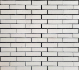white brick wall background with black seams between stones