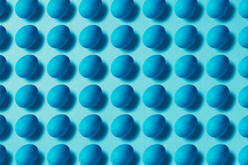 Blue easter eggs on blue background. Table top flat lay shot.