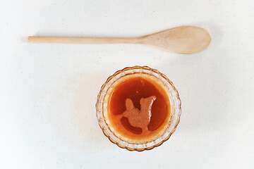 Orange organic lotion (toner) or juice and wooden spoon